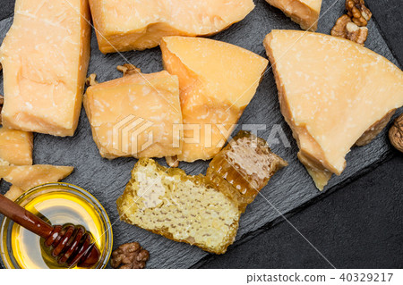 pieces of parmesan or parmigiano cheese and honey pieces of parmesan or parmigiano cheese and honey 40329217