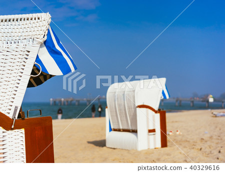 Close up of beach chairs on sandy beach on Travemuende, Luebeck Bay, Germany Close up of beach chairs on sandy beach on Travemuende, Luebeck Bay, Germany 40329616