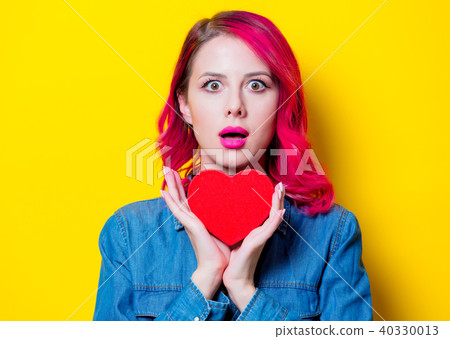 girl in blue shirt holding a red heart shape box 40330013