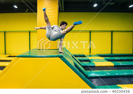trampoline jumper performs acrobatic exercises on the trampoline 40330456