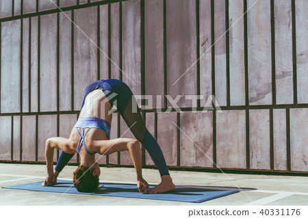 Fitness woman doing yoga urban practice outdoors. Healthy young girl practising yoga on seaside 40331176