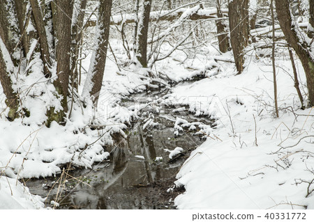 Frozen and snow covered pond Frozen and snow covered pond 40331772