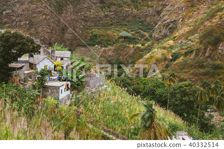 Local stone houses of small village between lush green vegetation and mountain landscape. Santo 40332514