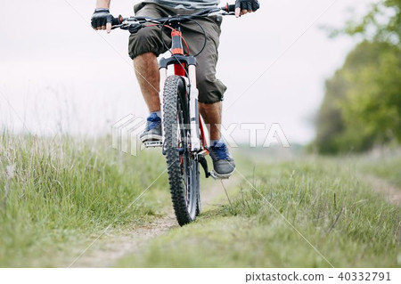 Man riding a bicycle, cross-country riding Man riding a bicycle, cross-country riding 40332791