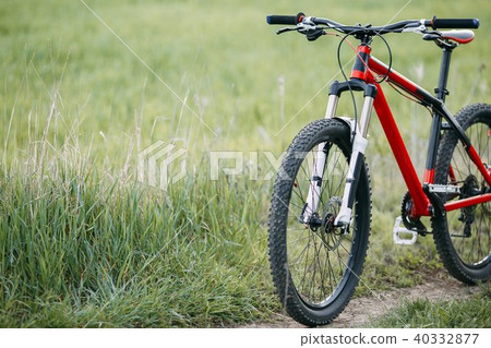 Cropped image of bicycle in green summer grass Cropped image of bicycle in green summer grass 40332877
