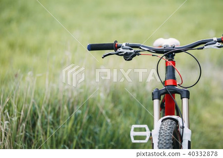 Cropped image of bicycle in green summer grass Cropped image of bicycle in green summer grass 40332878