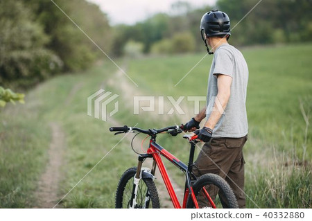 Man traveling in the countryside riding a bicycle Man traveling in the countryside riding a bicycle 40332880