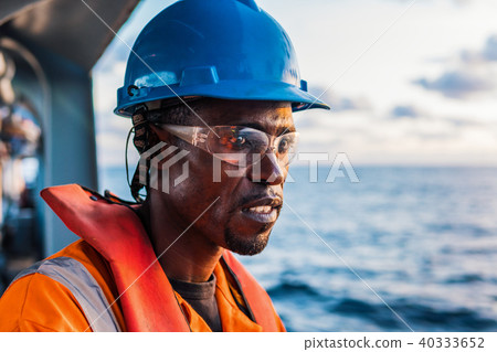 Seaman AB or Bosun on deck of vessel or ship , wearing PPE 40333652