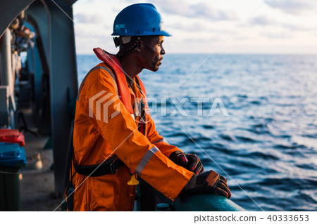Seaman AB or Bosun on deck of vessel or ship , wearing PPE 40333653
