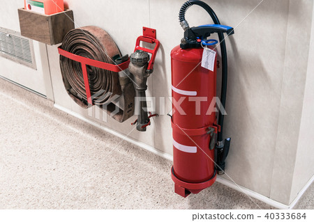 Fire extinguisher and fire hose reel in corridor 40333684