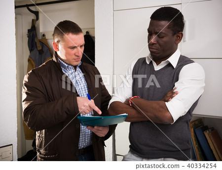 Men with documents having conflict about services offered 40334254