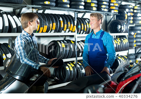 Technician standing with customer in shop Technician standing with customer in shop 40334276