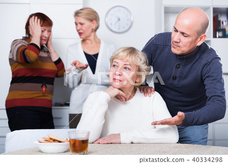 Mature man is warm apologizing to woman after quarrel Mature man is warm apologizing to woman after quarrel 40334298