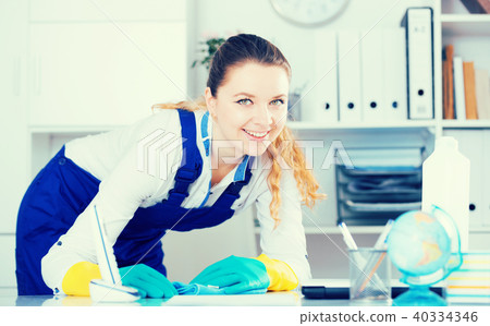Smiling woman cleaning room Smiling woman cleaning room 40334346