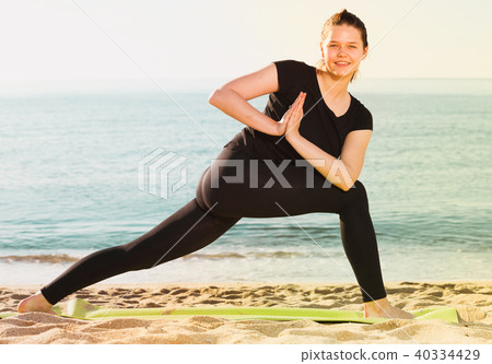 Female in black T-shirt is practicing yoga 40334429