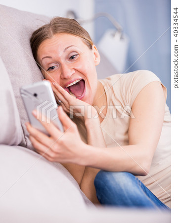 Laughing woman with phone Laughing woman with phone 40334544