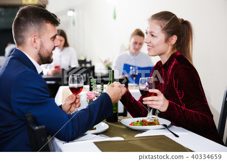 Elegant female and her boyfriend are celebrating date for dinner Elegant female and her boyfriend are celebrating date for dinner 40334659