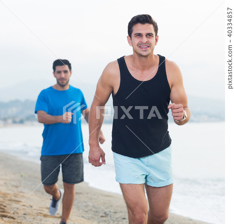 Adult men are jogging together 40334857