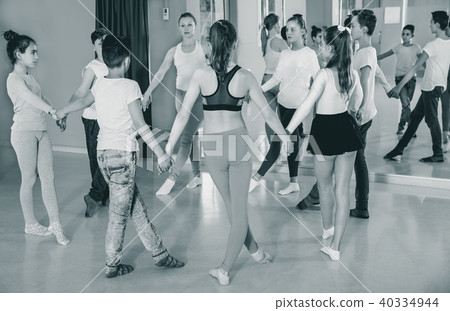 Children with teacher holding hands and dancing in dance school Children with teacher holding hands and dancing in dance school 40334944