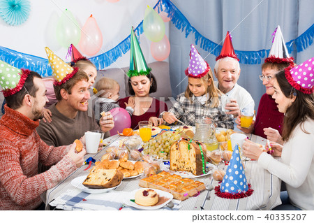 family celebrating children’s birthday during festive dinner family celebrating children’s birthday during festive dinner 40335207