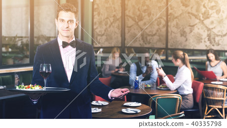 Elegant waiter with serving tray 40335798