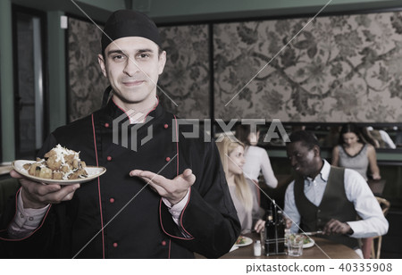 Proud chef offering dish for tasting Proud chef offering dish for tasting 40335908