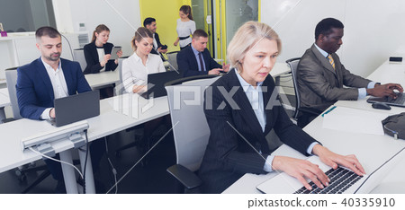 Senior businesswoman concentrated on work with laptop Senior businesswoman concentrated on work with laptop 40335910