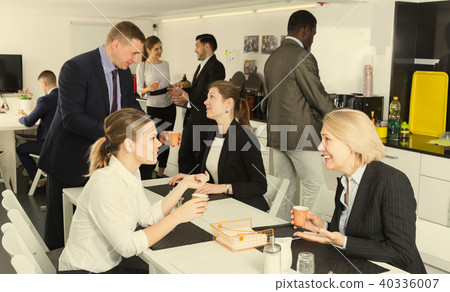 Women and men business colleagues relaxing at coffee break Women and men business colleagues relaxing at coffee break 40336007