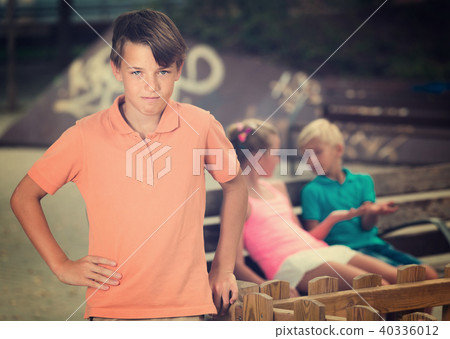 Portrait of boy 9-12 years old which is taking offense on his friends 40336012