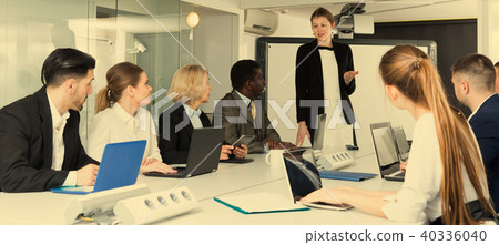 girl making presentation to colleagues 40336040