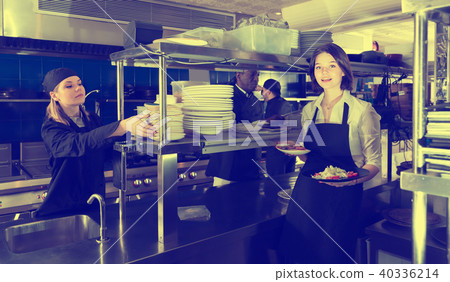 Portrait of glad waiter standing with order 40336214