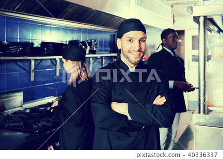 Smiling chef cook is posing on kitchen 40336337