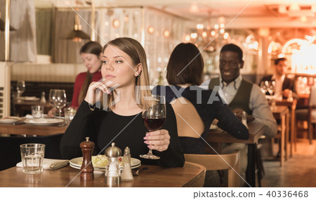 Pensive young woman in restaurant 40336468