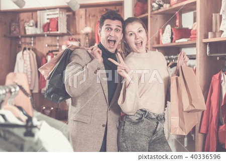 Young woman and man are standing satisfied with packadge after s 40336596