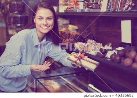 Woman selecting fine chocolates Woman selecting fine chocolates 40336692