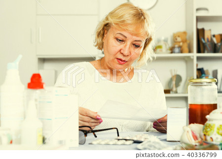 Mature woman with medicines and bills Mature woman with medicines and bills 40336799