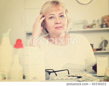 Mature woman with medicines and bills Mature woman with medicines and bills 40336831
