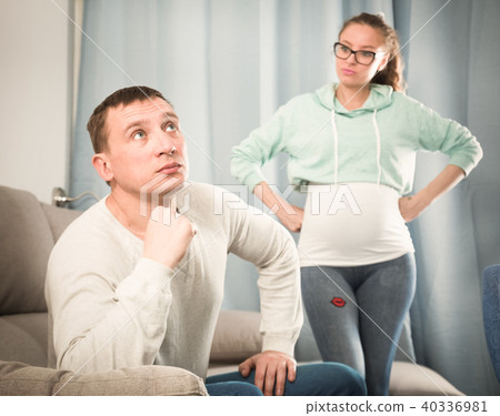 Husband and pregnant wife arguing at home 40336981