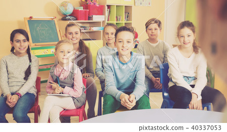 Elementary age group of pupil sitting and listening teacher Elementary age group of pupil sitting and listening teacher 40337053