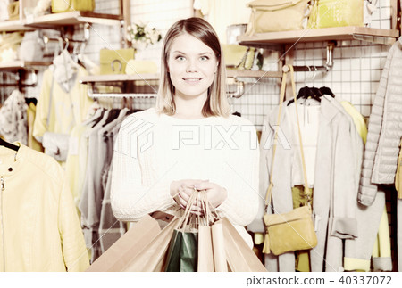 Woman carrying paper bags with purchases in fashion store 40337072