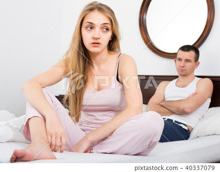Two young partners upset in bedroom. 40337079