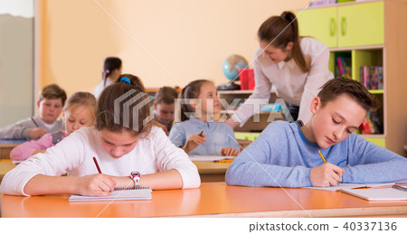 Portrait of schoolboy and children in classroom Portrait of schoolboy and children in classroom 40337136