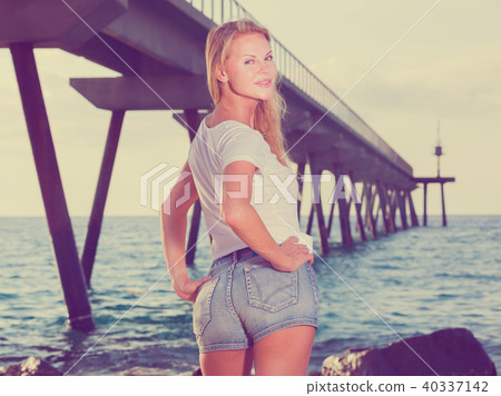 Female is posing on the rocks in her free time 40337142