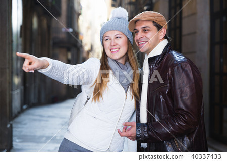tourists in hats and scarfs pointing finger tourists in hats and scarfs pointing finger 40337433