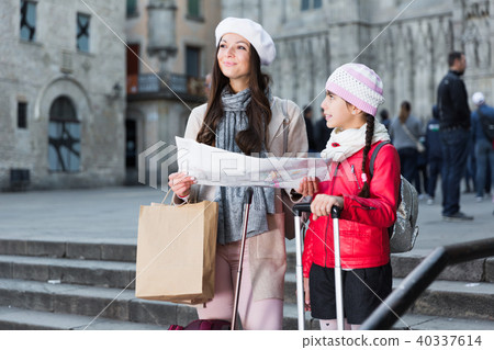 Cheerful girl and woman with map in scarf 40337614