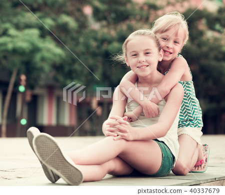 Two small happy sisters outdoors Two small happy sisters outdoors 40337679