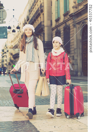 female and child girl going with baggage female and child girl going with baggage 40337782