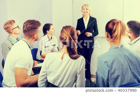 Female teacher lecturing to students at auditorium 40337990