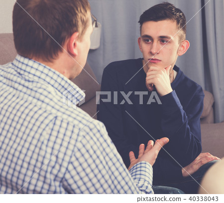 Man with his adult son are serious talking about life together 40338043
