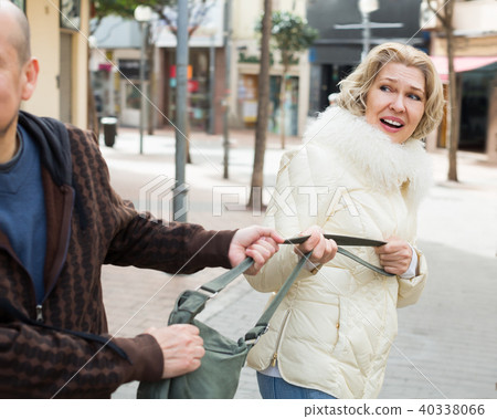 Portrait of frightened adult woman and robber Portrait of frightened adult woman and robber 40338066